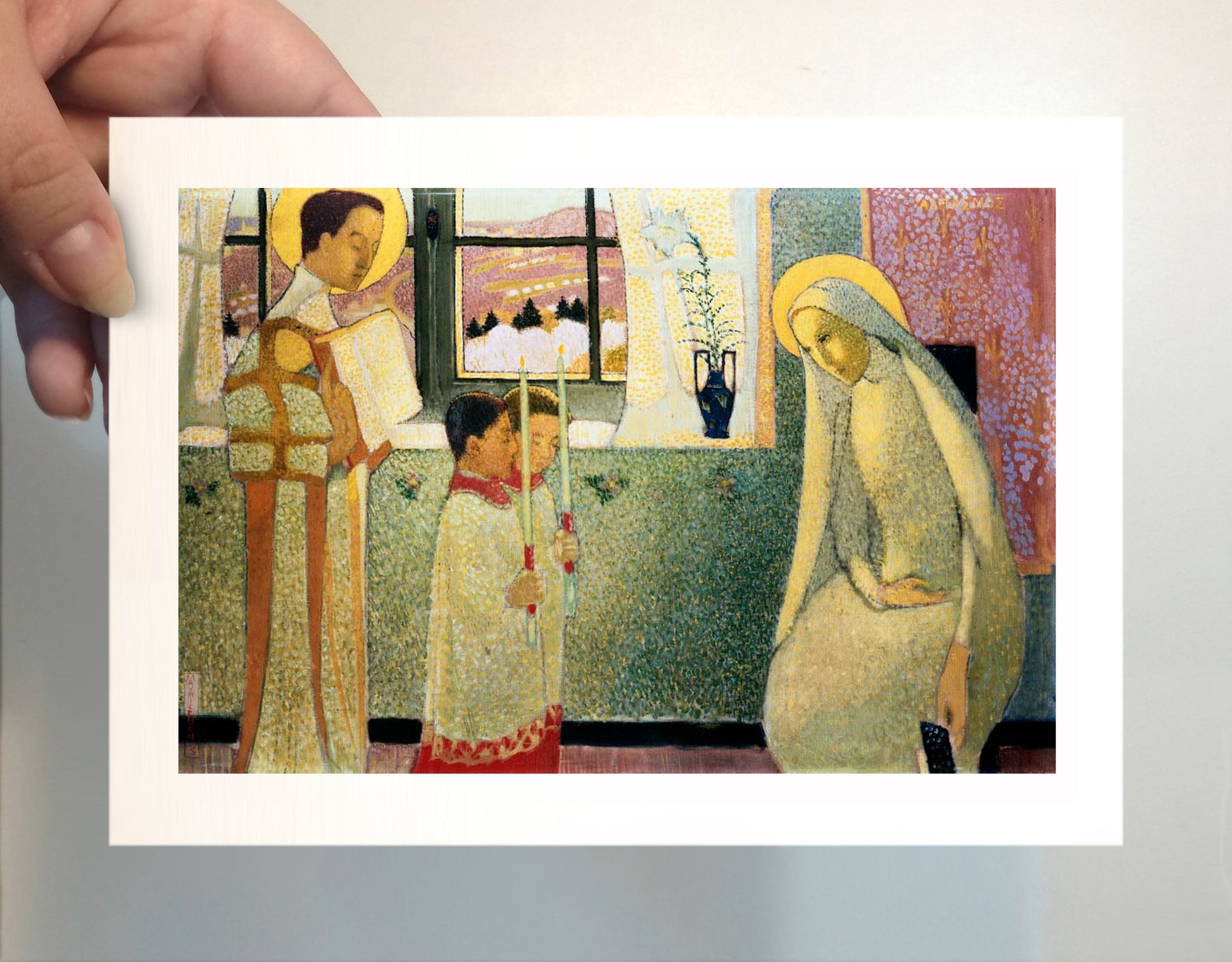 a person holding up a picture of a woman and child