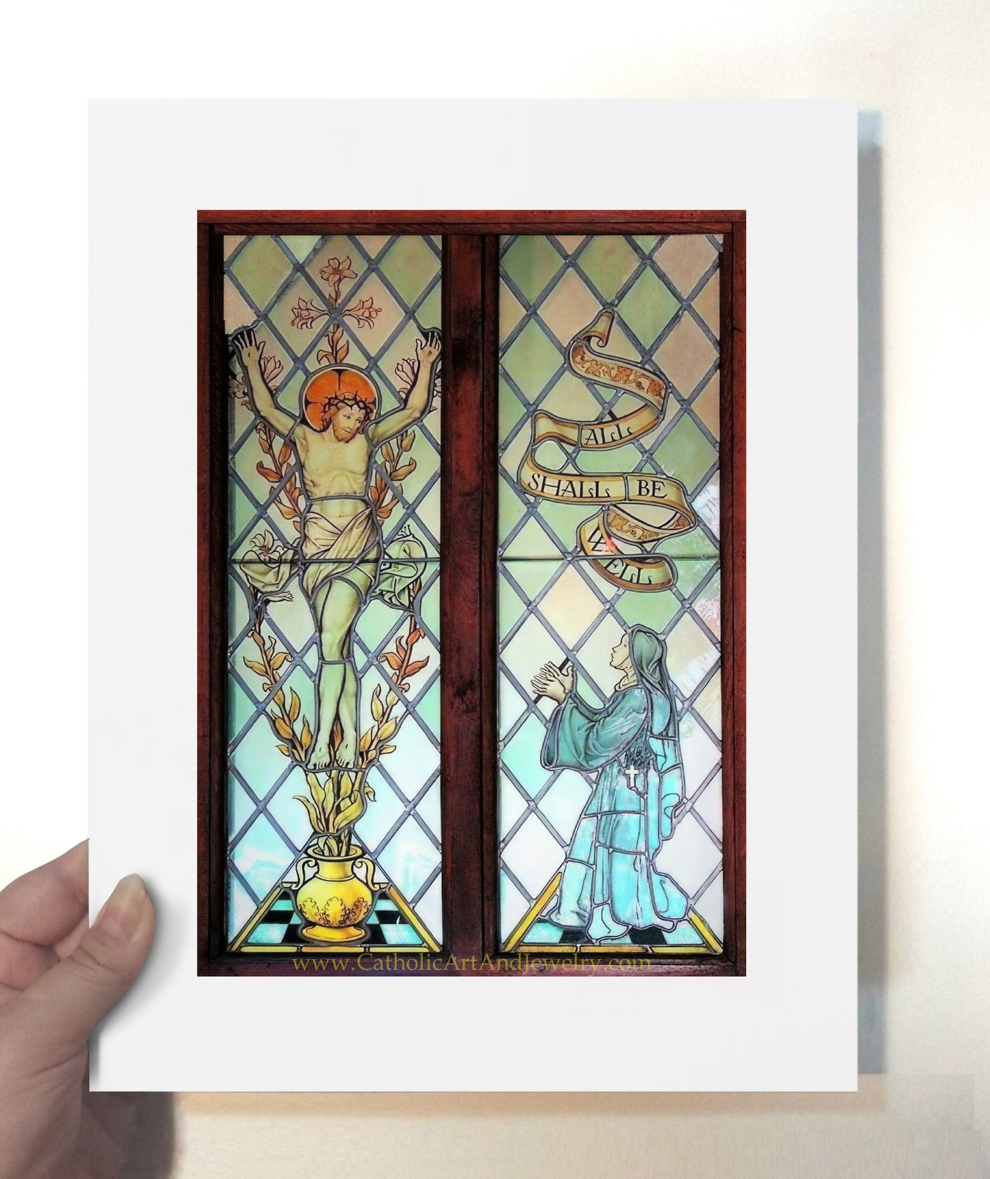 a person holding up a picture of a stained glass window