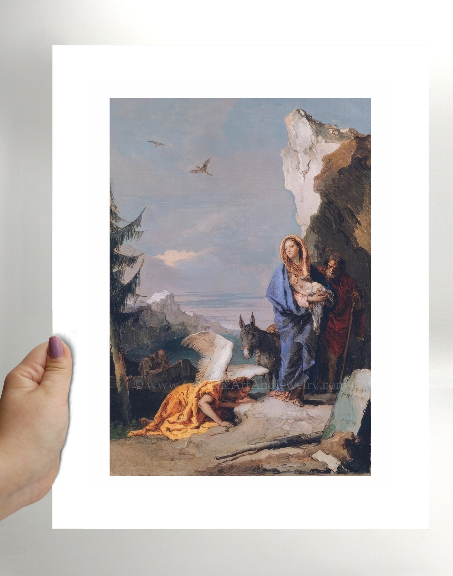 a person holding a picture of a painting