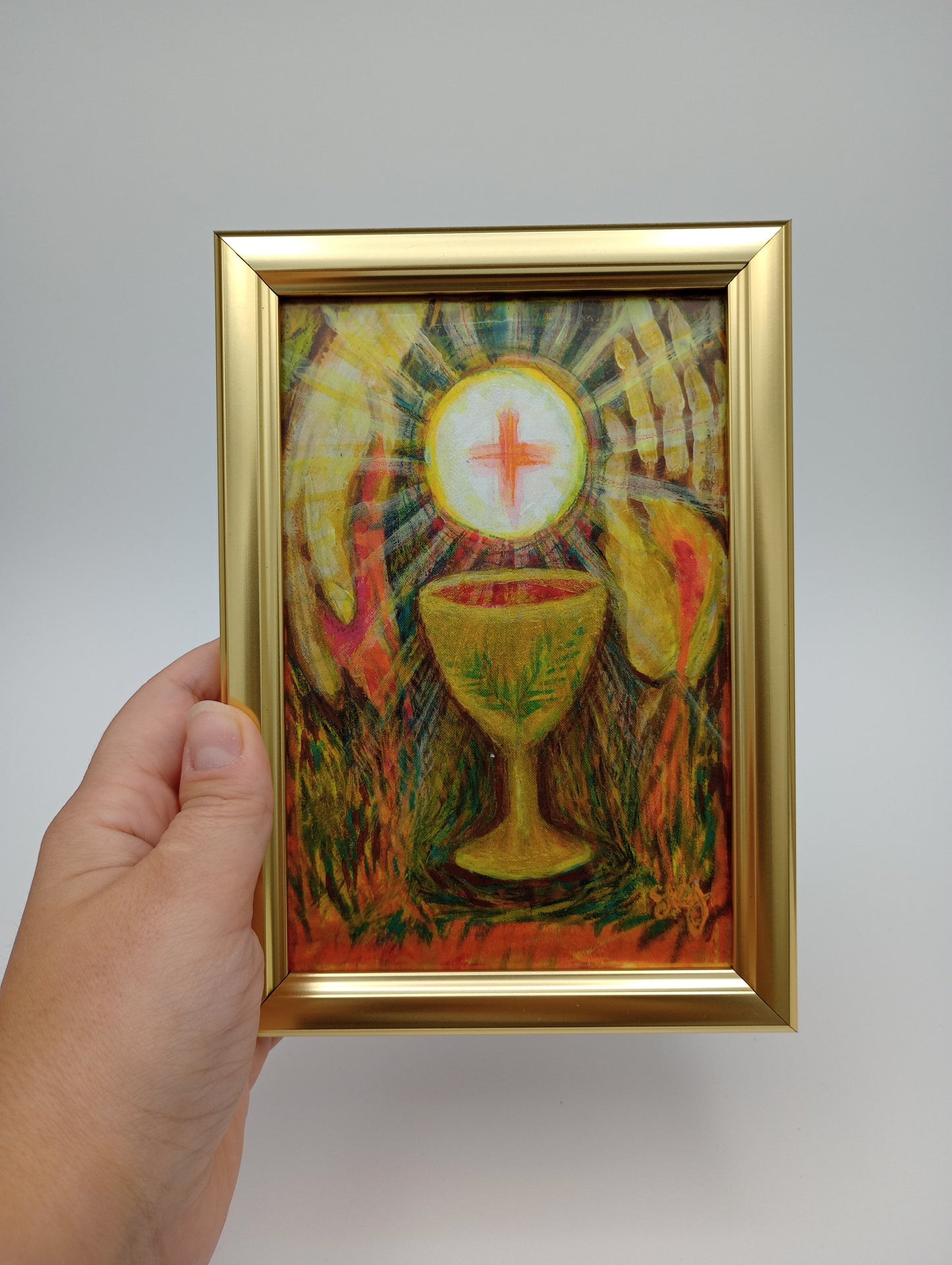 a person holding a painting in their hand