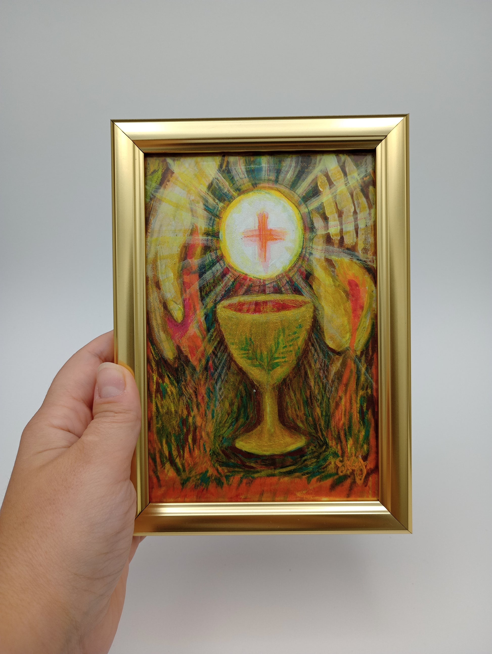 a person holding a painting in their hand