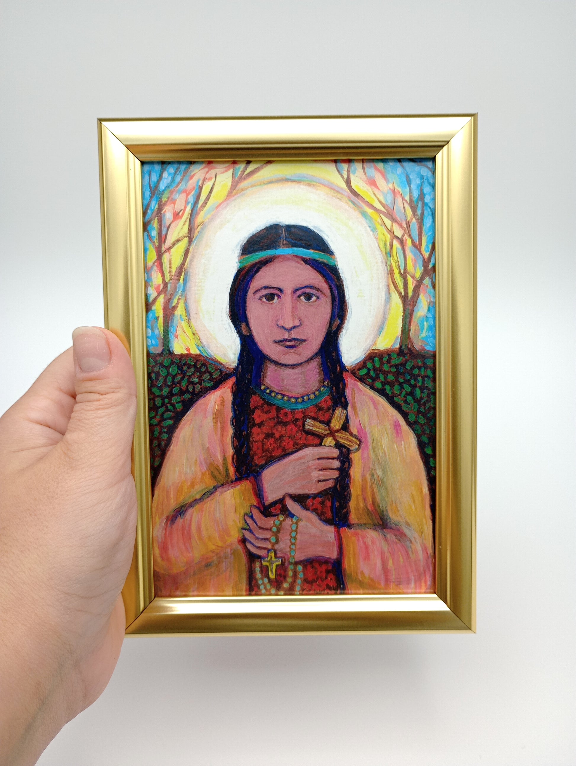 a painting of a woman holding a picture of herself