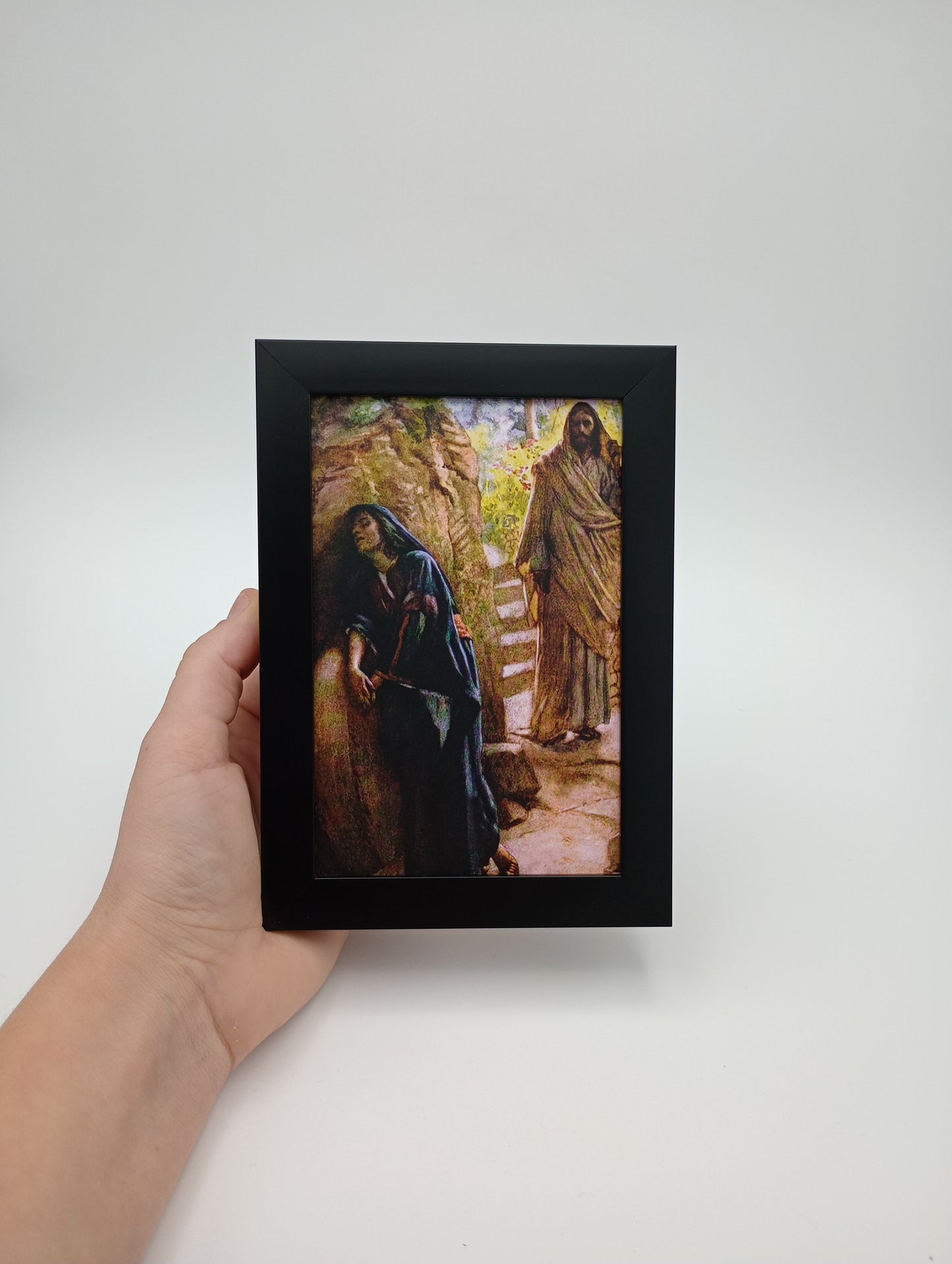 a person holding a picture of a lizard in a frame