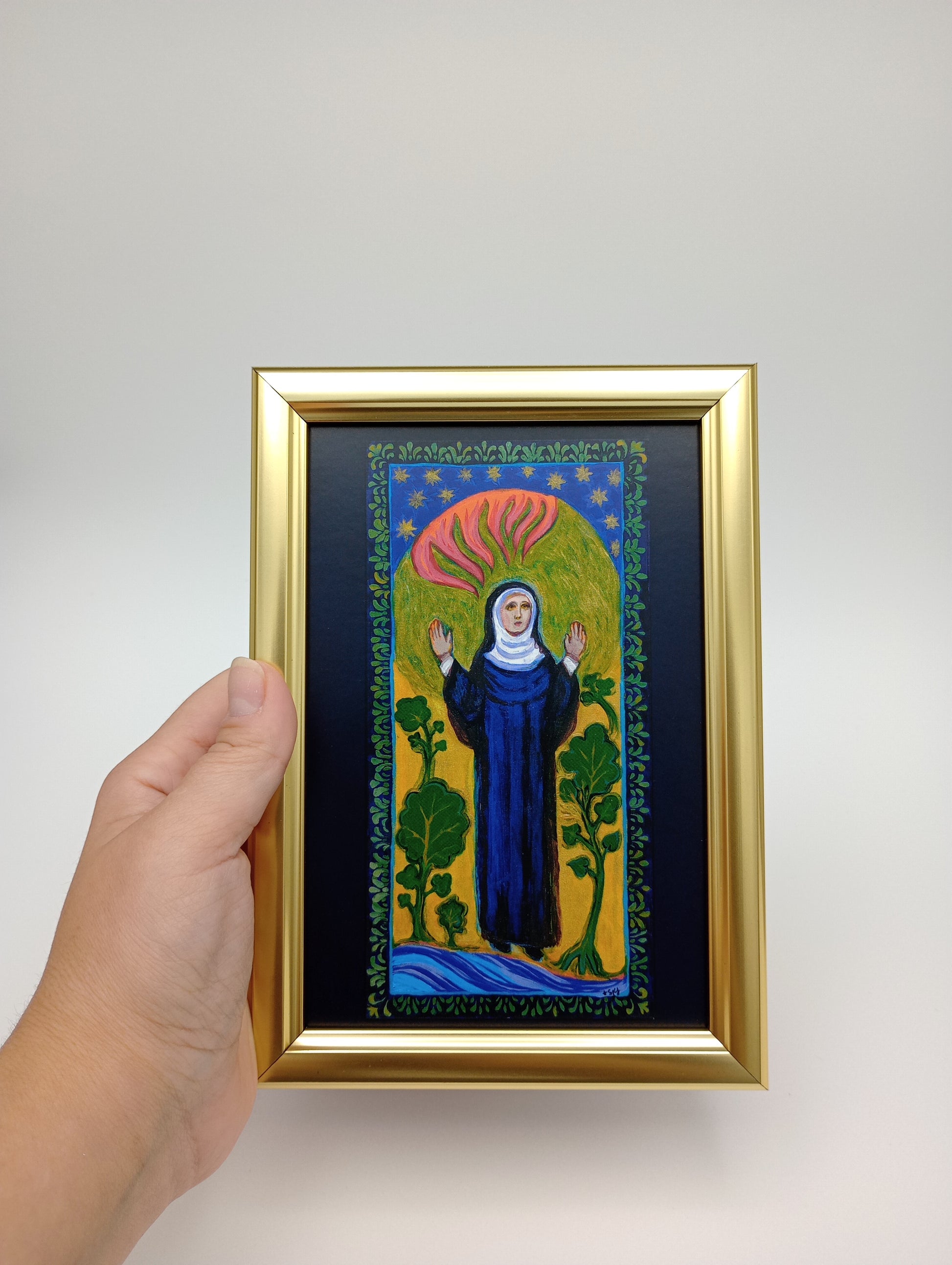 a person holding a painting in their hand