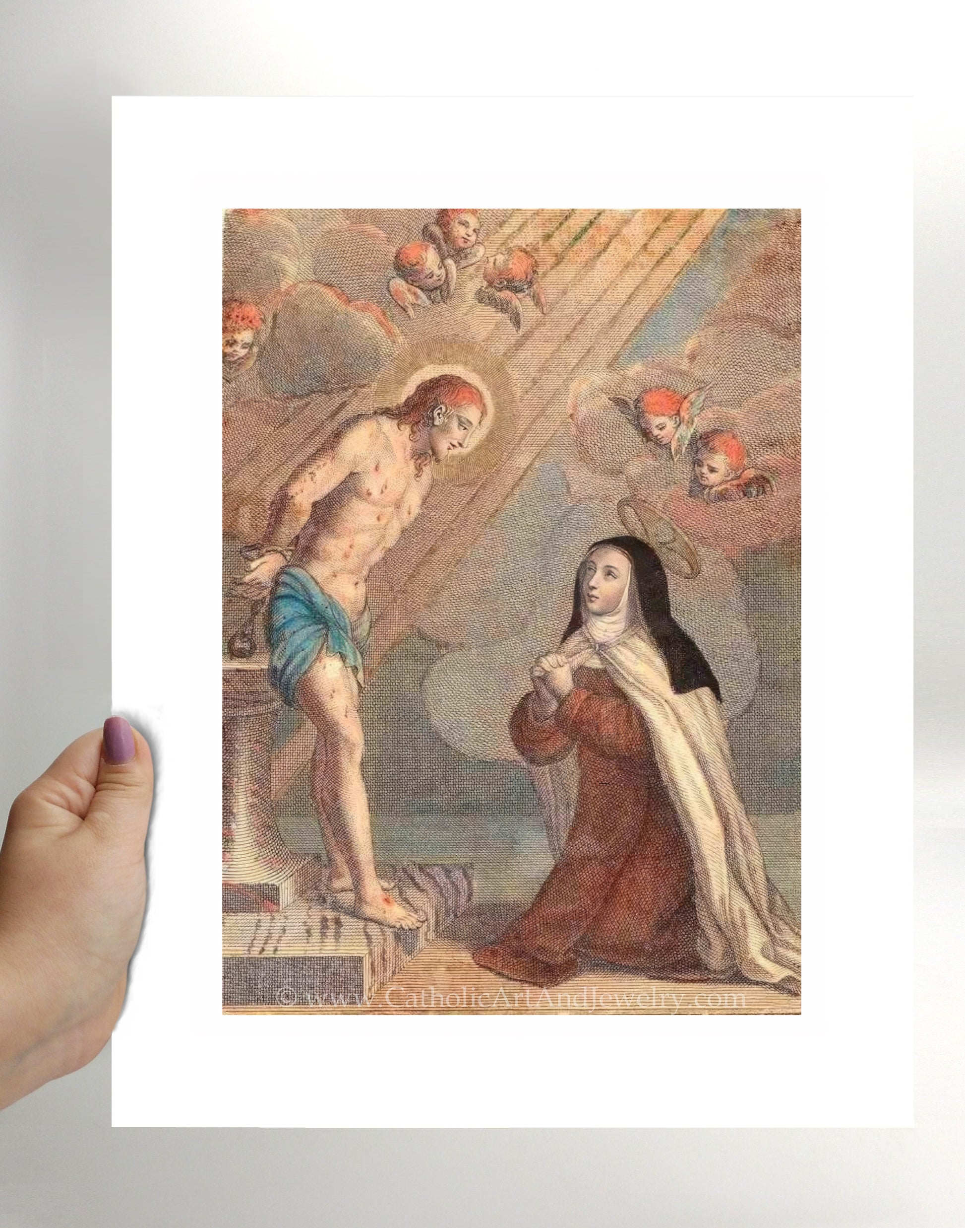 a hand holding a card with a painting of jesus