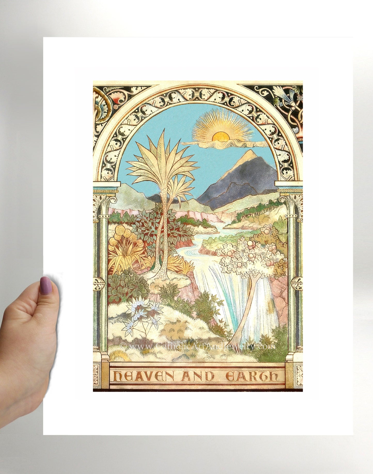 a person holding up a card with a painting on it