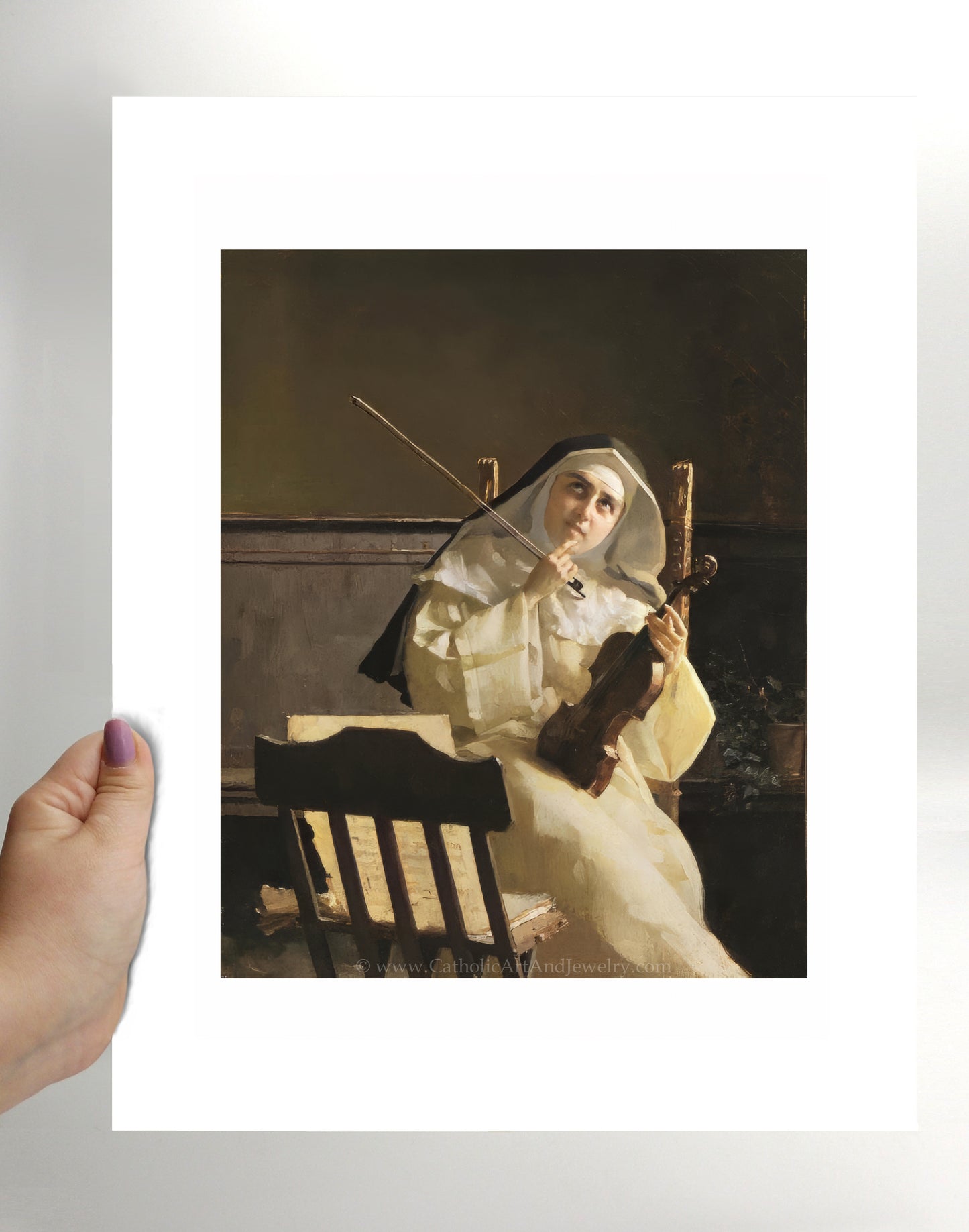 a person holding a picture of a nun holding a violin