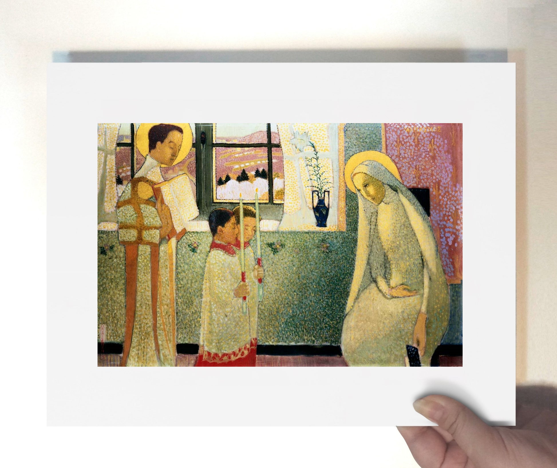 a person holding up a picture of a woman and child