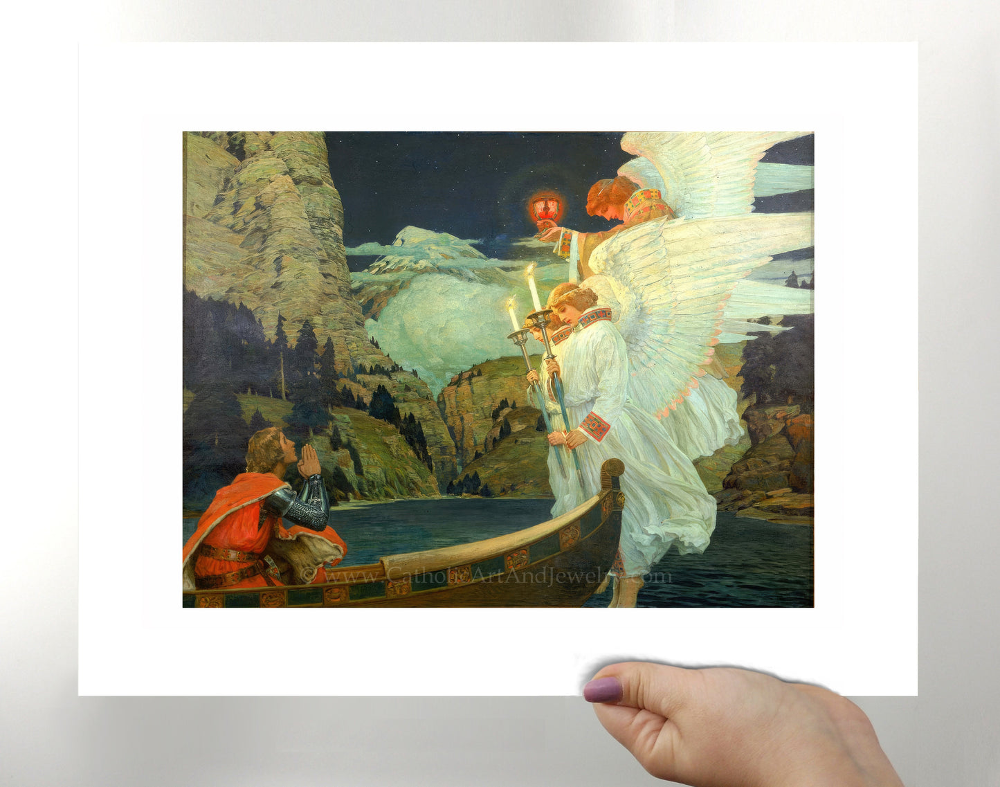 a person holding up a picture of an angel