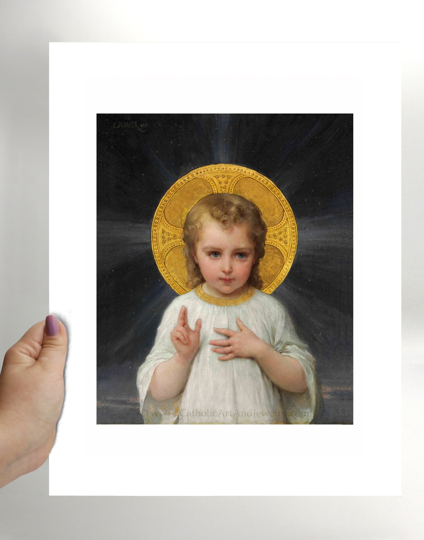 a hand holding a picture of a little girl