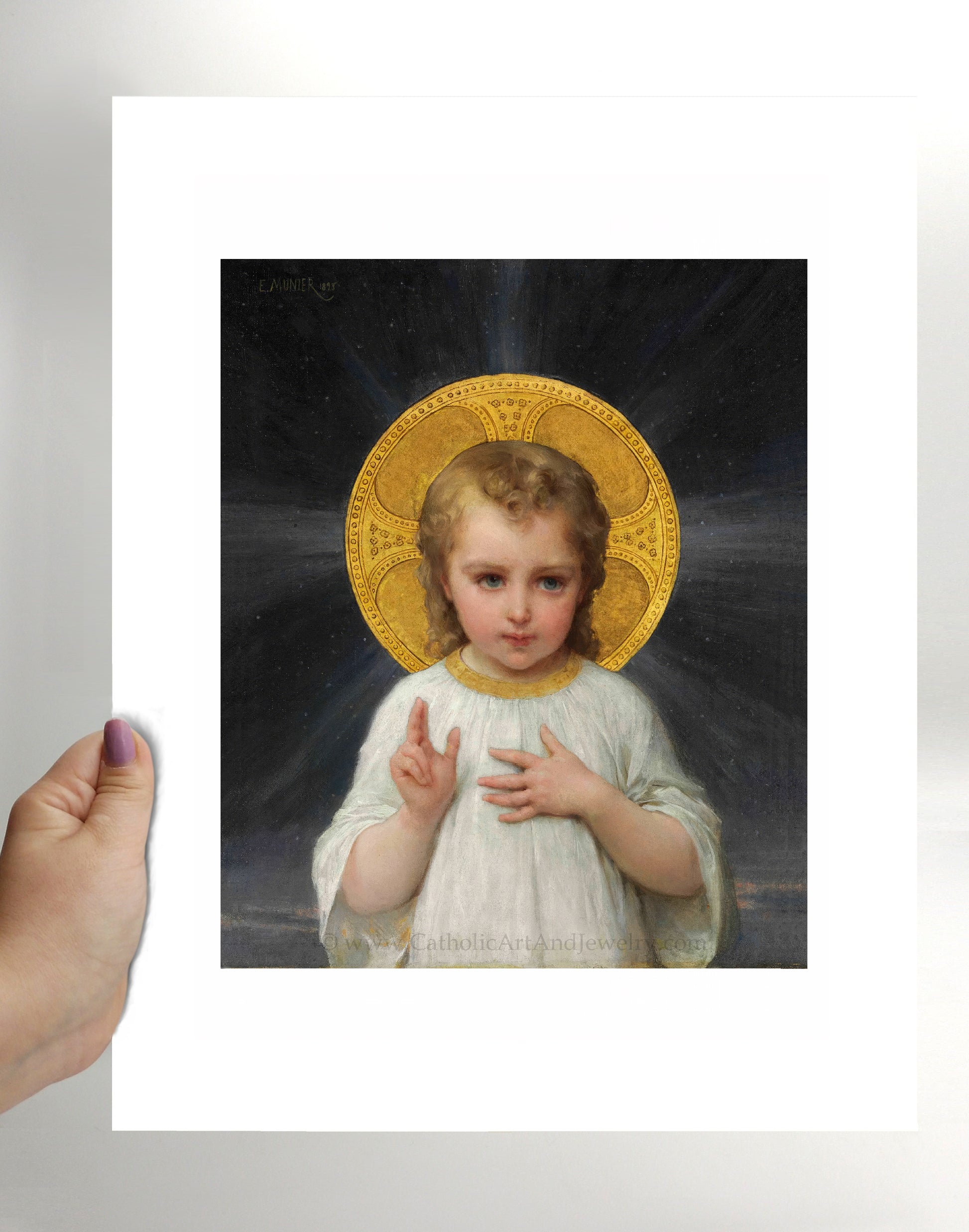 a hand holding a picture of a little girl