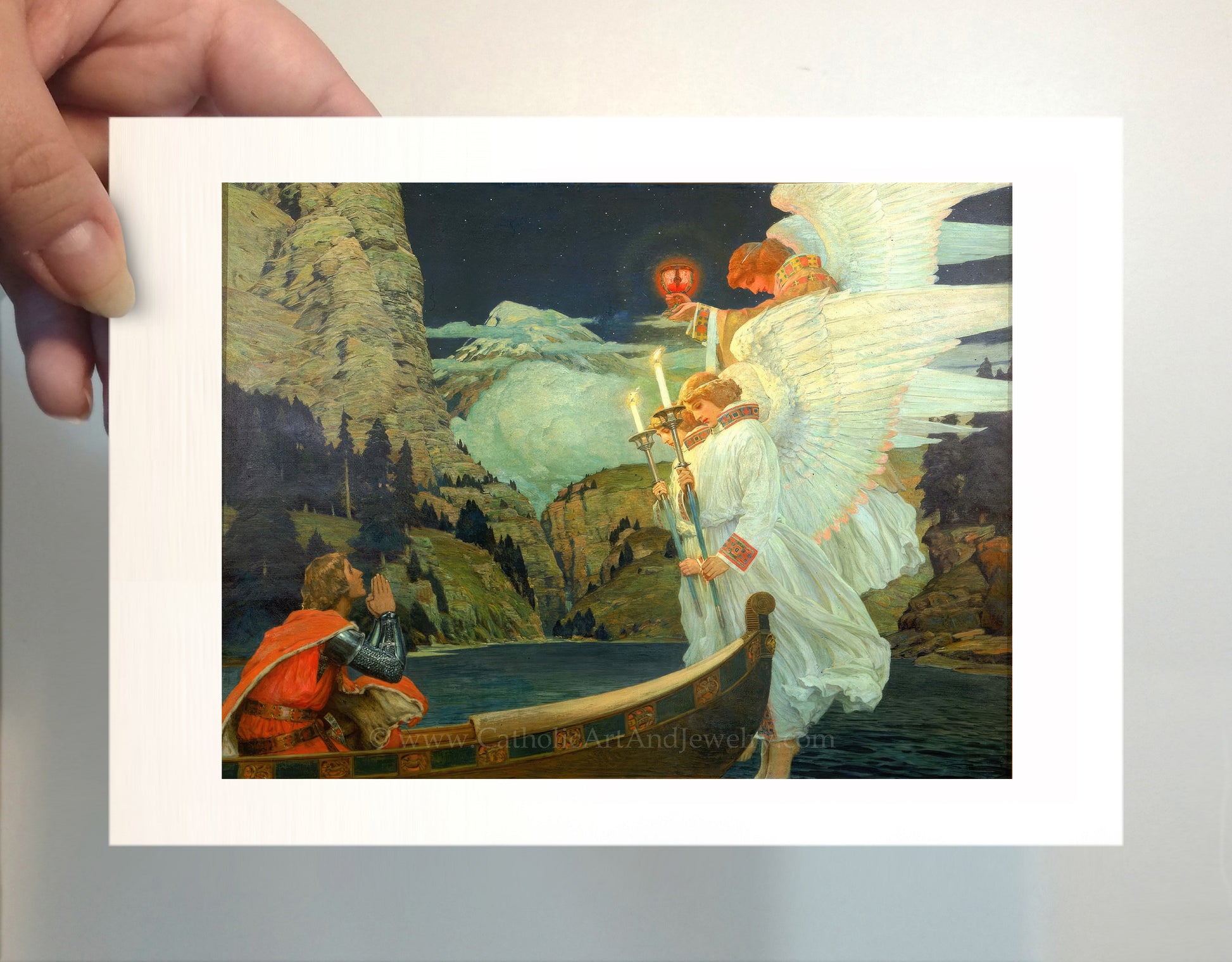 a person holding a picture of a painting