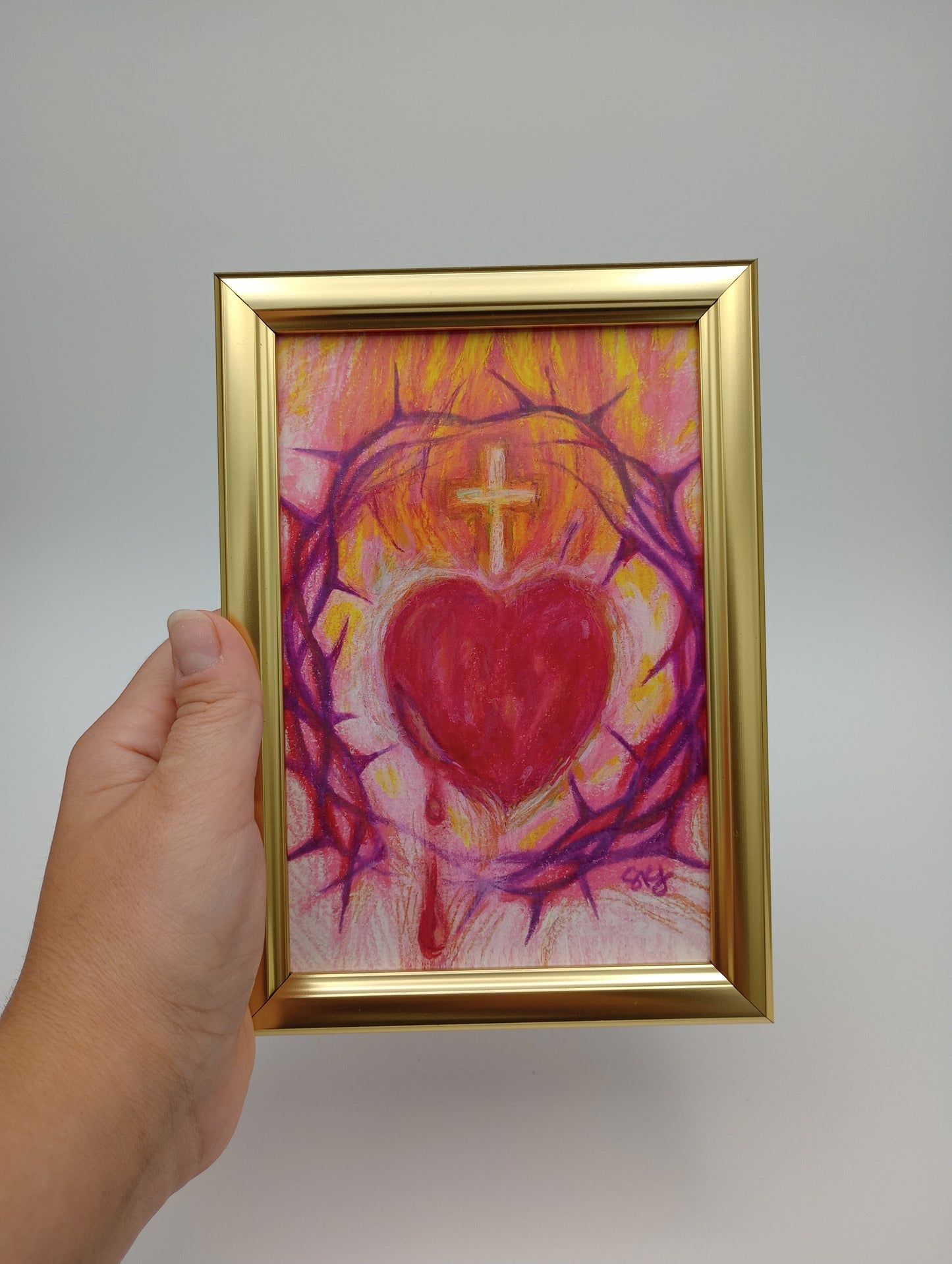 a person holding a painting in their hand