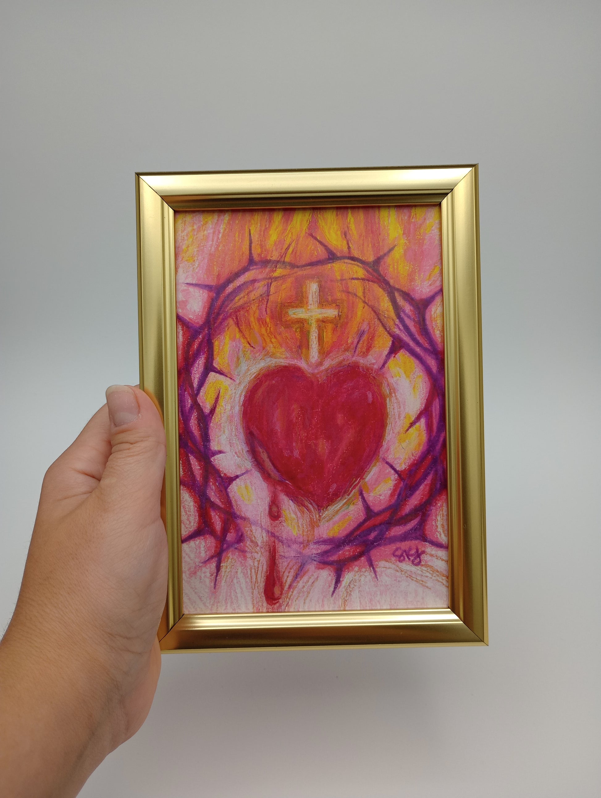 a person holding a painting in their hand