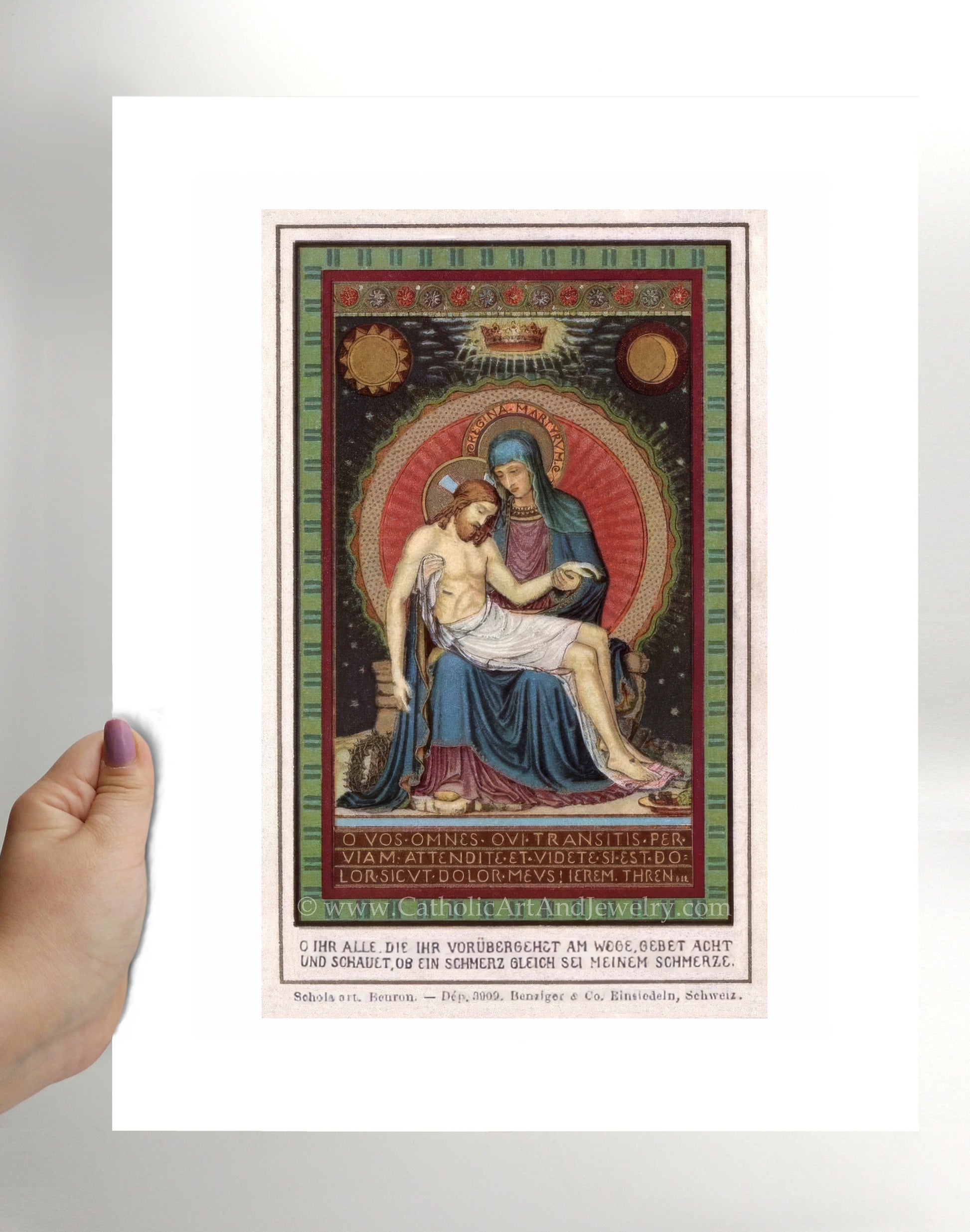 a person holding up a picture of jesus and mary