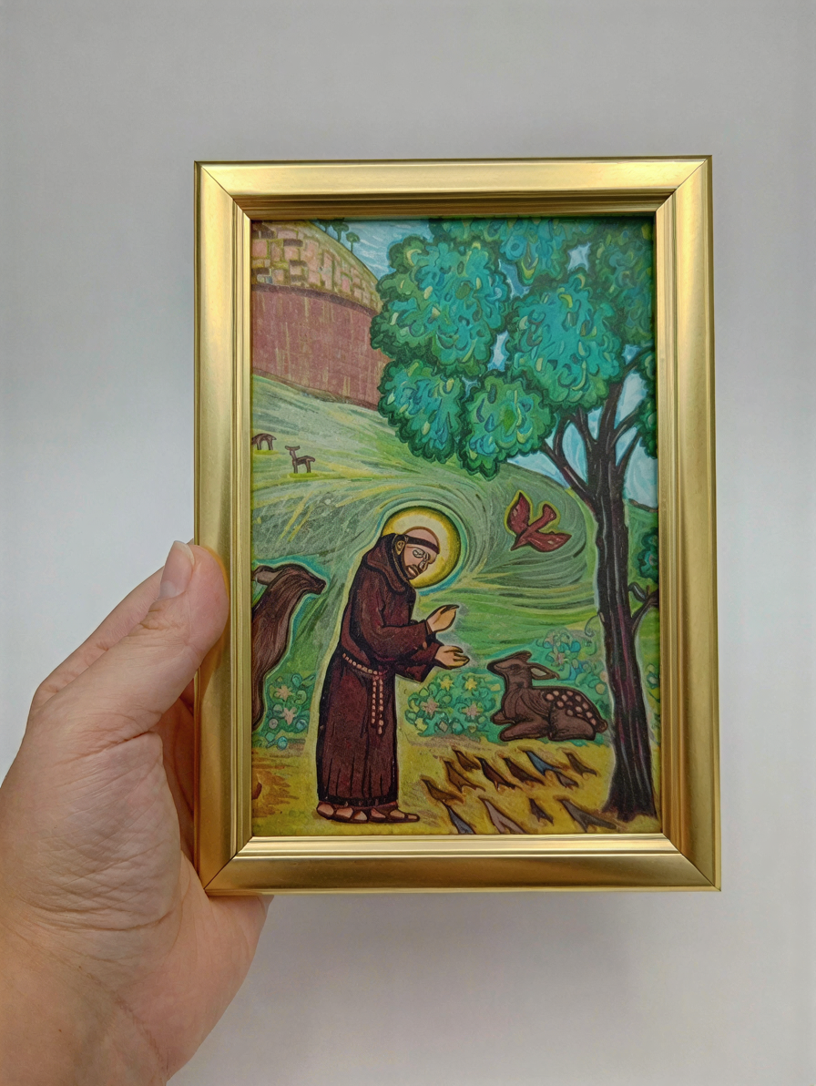A hand is holding a framed painting depicting a pastoral scene with a person in a brown robe, a tree, and animals in the background.