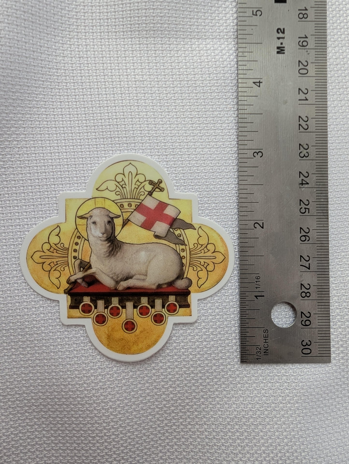 a ruler and a sticker with a seal on it