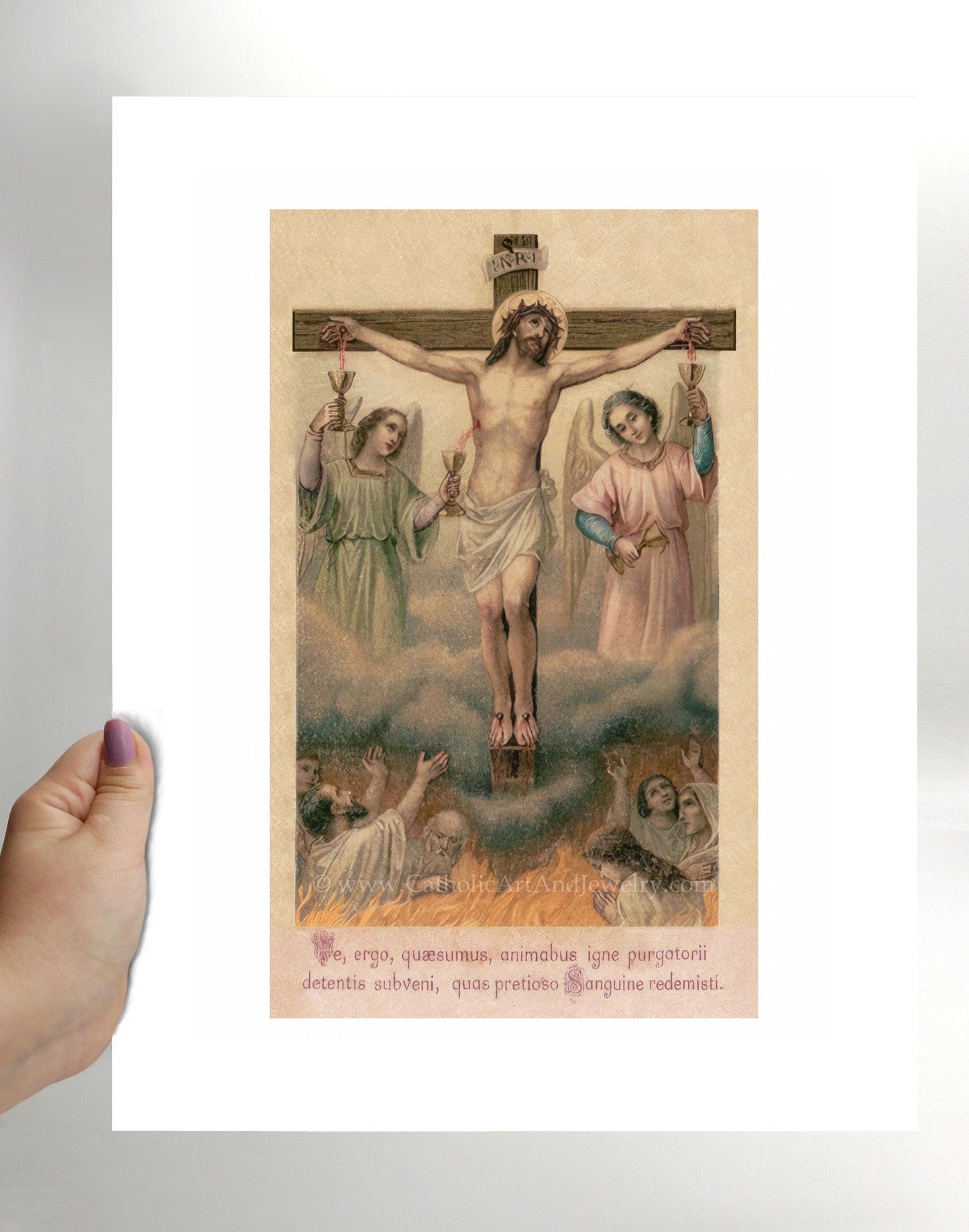 a person holding up a picture of jesus on the cross