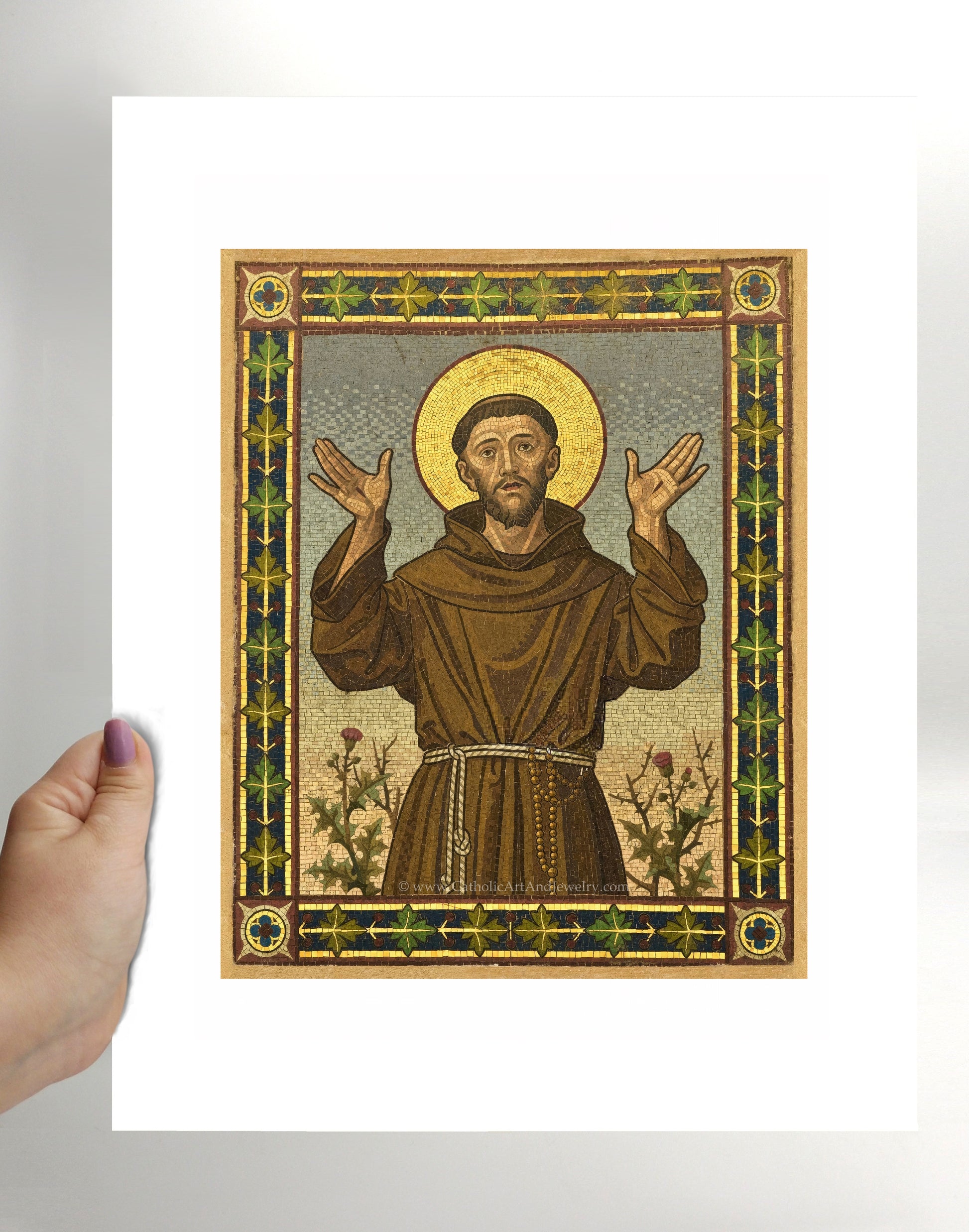 a hand holding a card with a picture of jesus