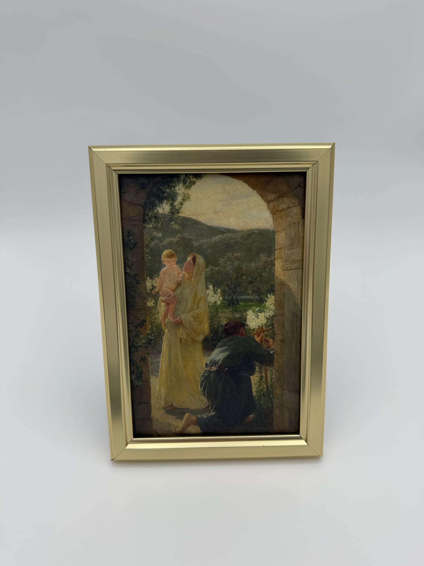 The image is a framed painting depicting a woman in a yellow dress standing in a doorway, with a man in a black suit visible through the doorway.