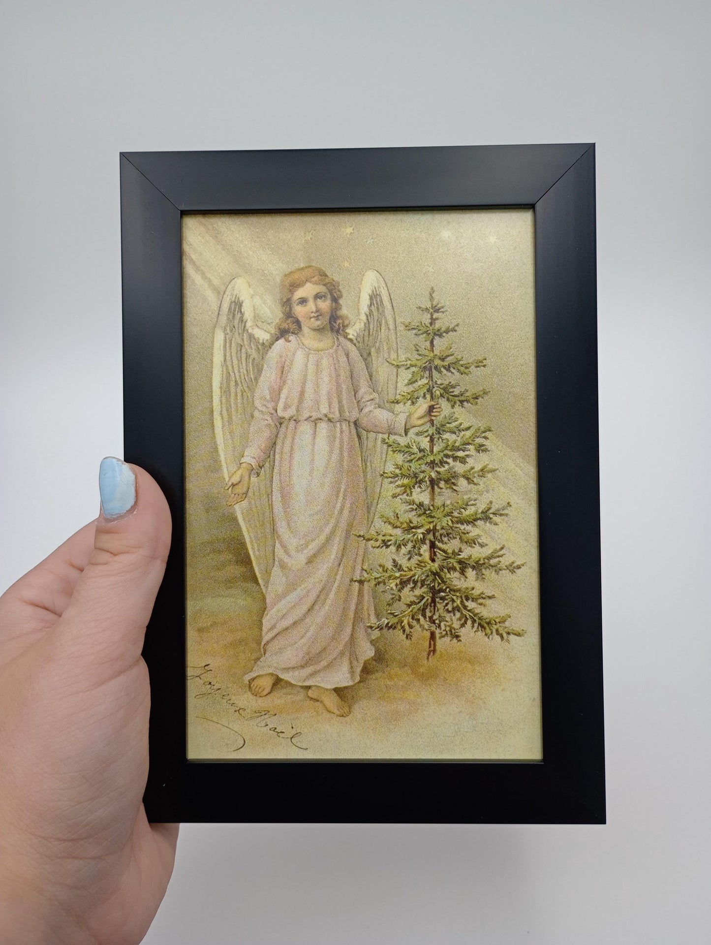a painting of an angel holding a christmas tree