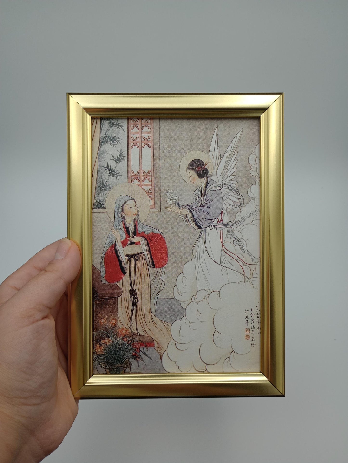 a person holding up a picture of a bird