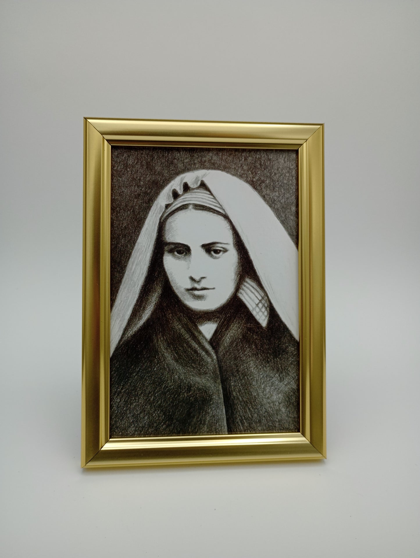 a portrait of a woman in a gold frame