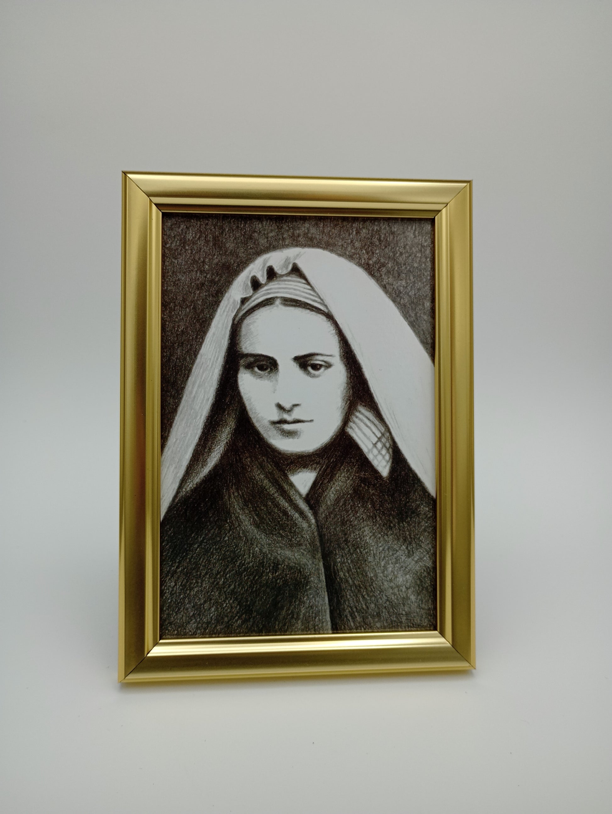 a portrait of a woman in a gold frame