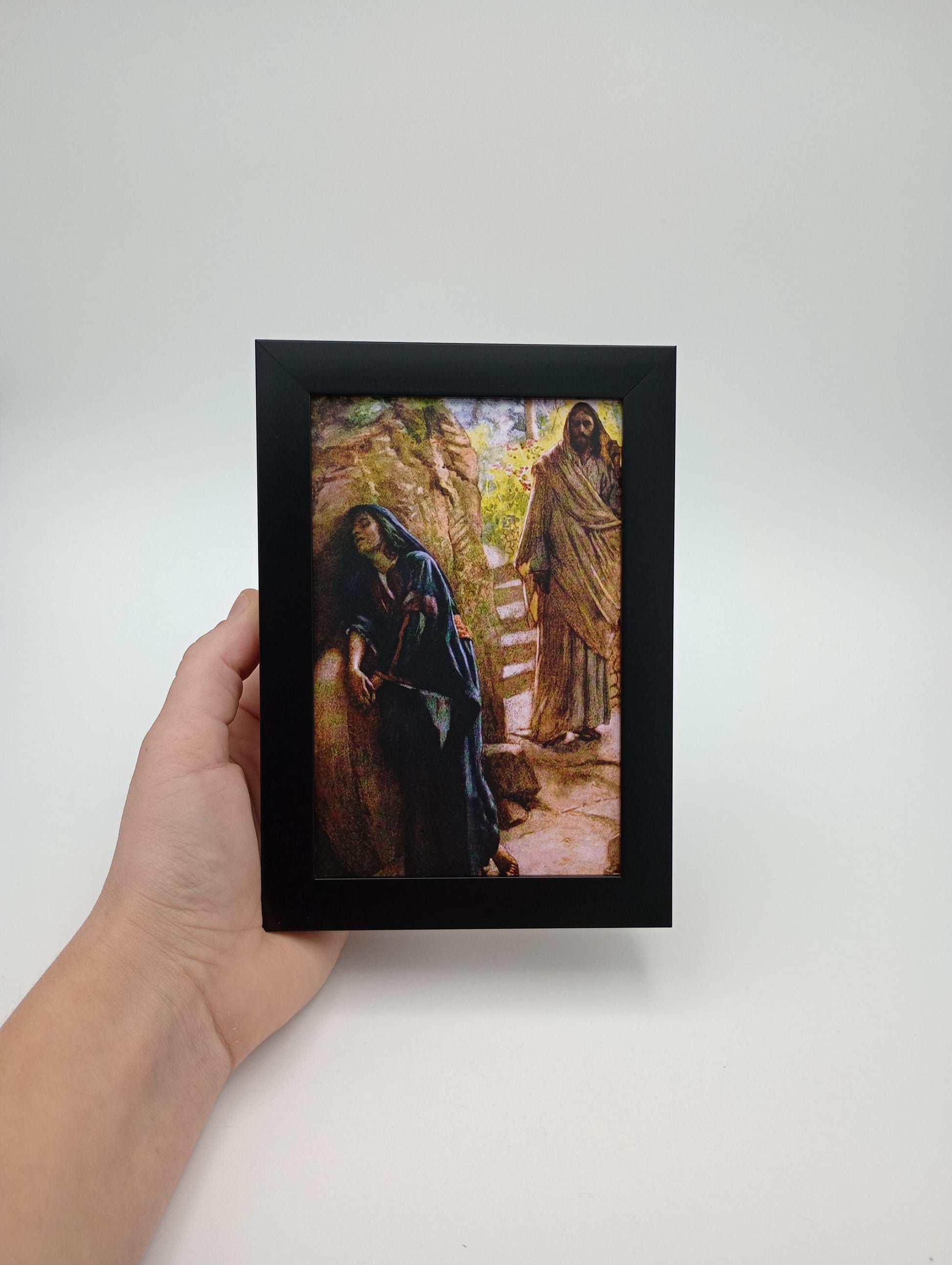 a person holding a picture of a lizard in a frame