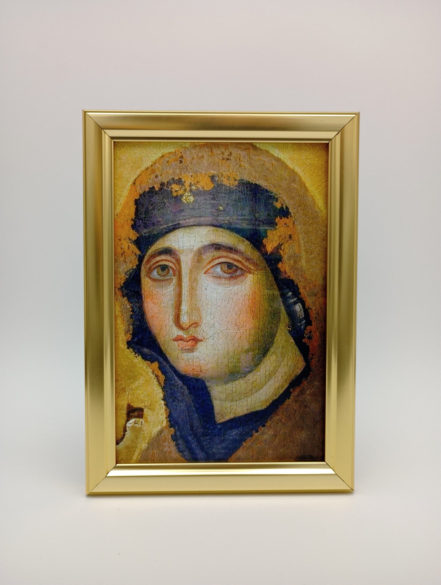 a painting of a woman in a gold frame