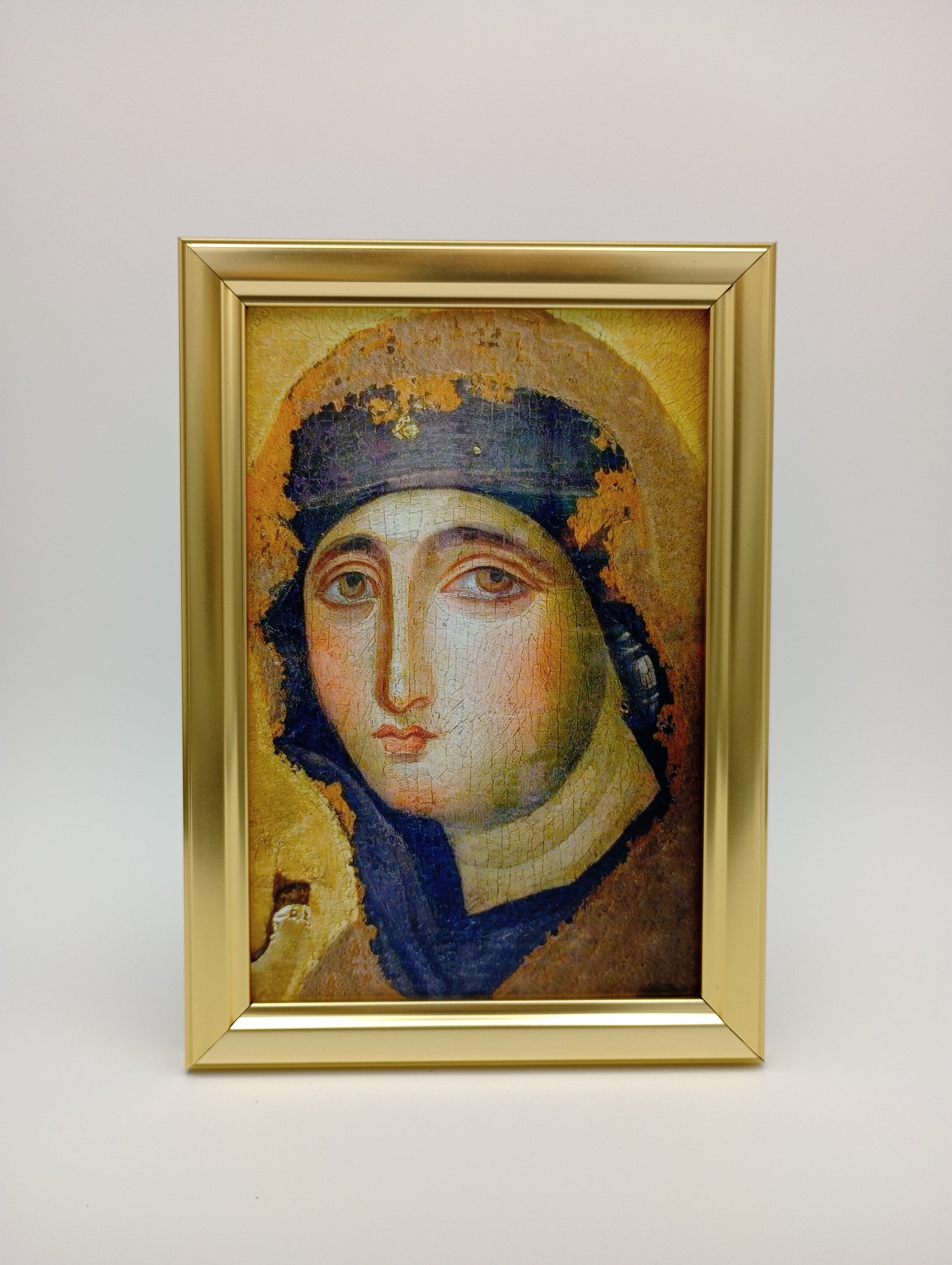a painting of a woman in a gold frame