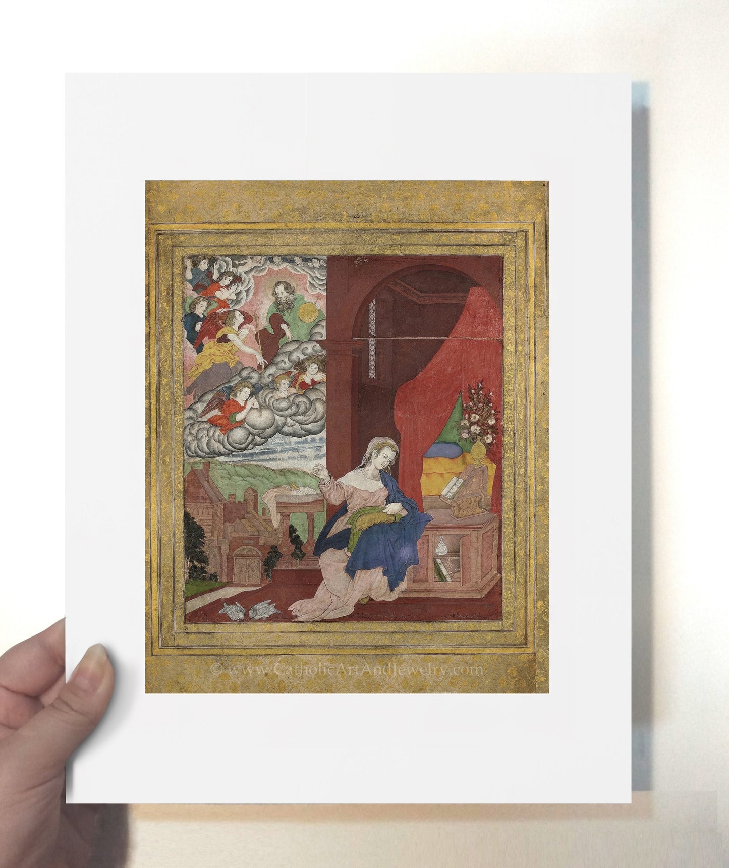a person holding up a picture of a painting