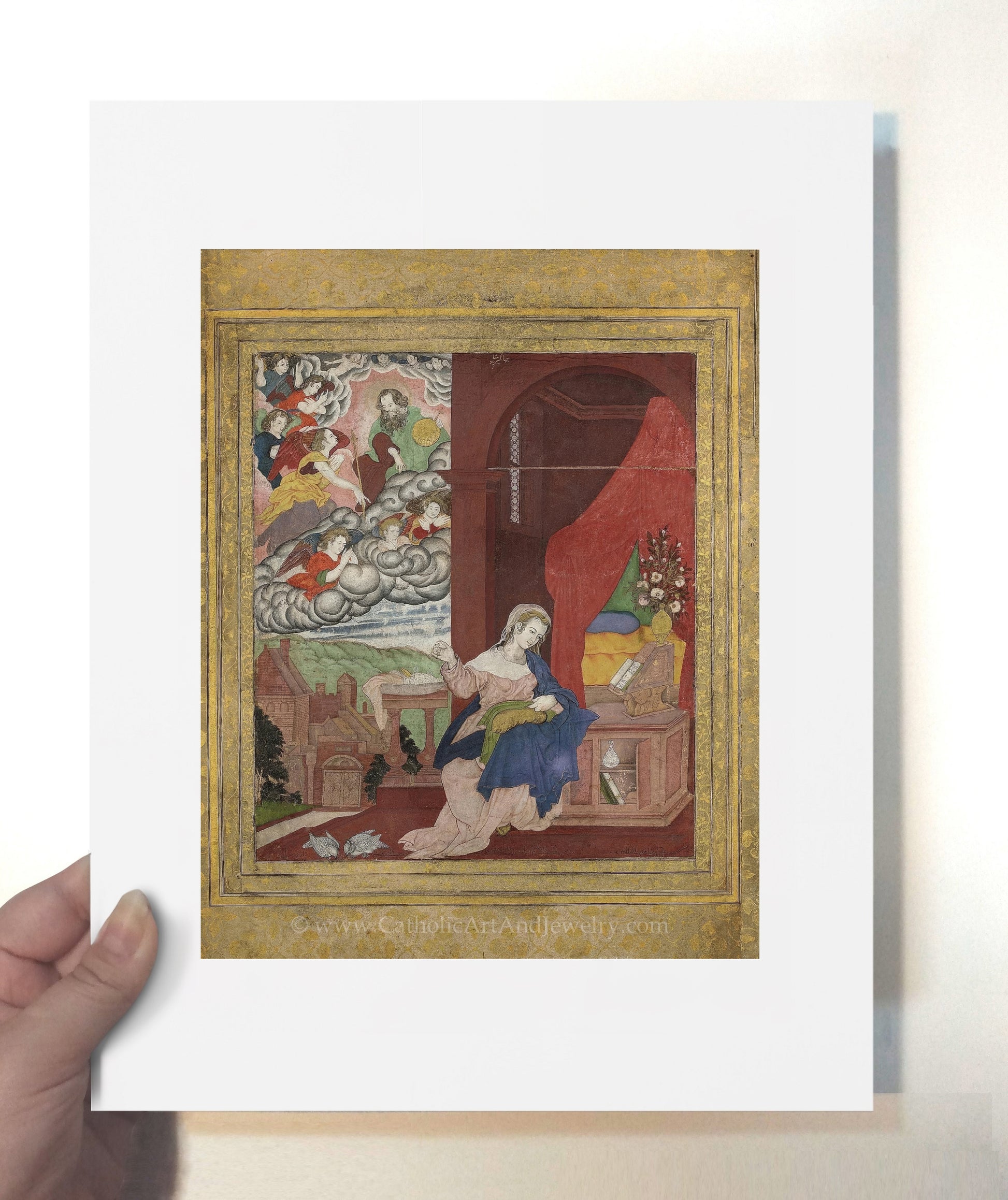a person holding up a picture of a painting