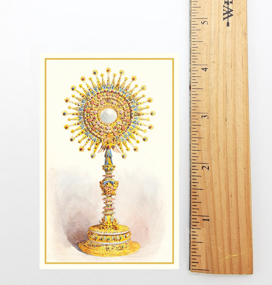 A golden, ornate religious object with a central white circle, surrounded by intricate designs and patterns, is depicted in the image.