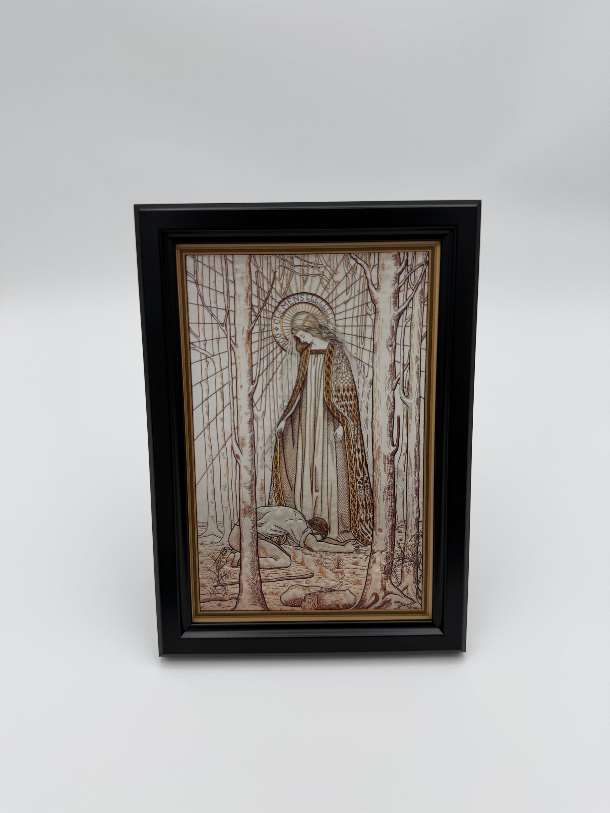 The image is a framed artwork hanging on a wall, depicting a person sitting in a boat on a river.