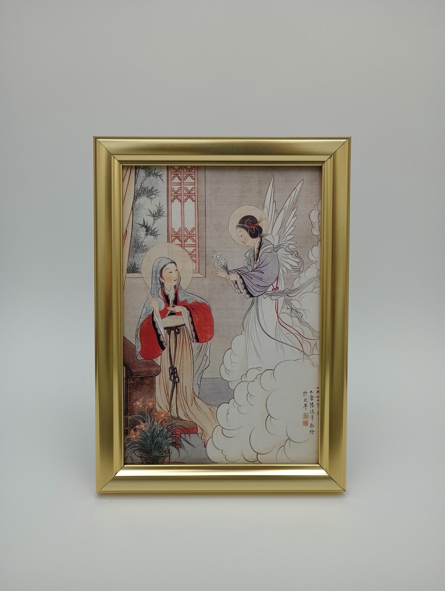 a painting hanging on a wall with a gold frame