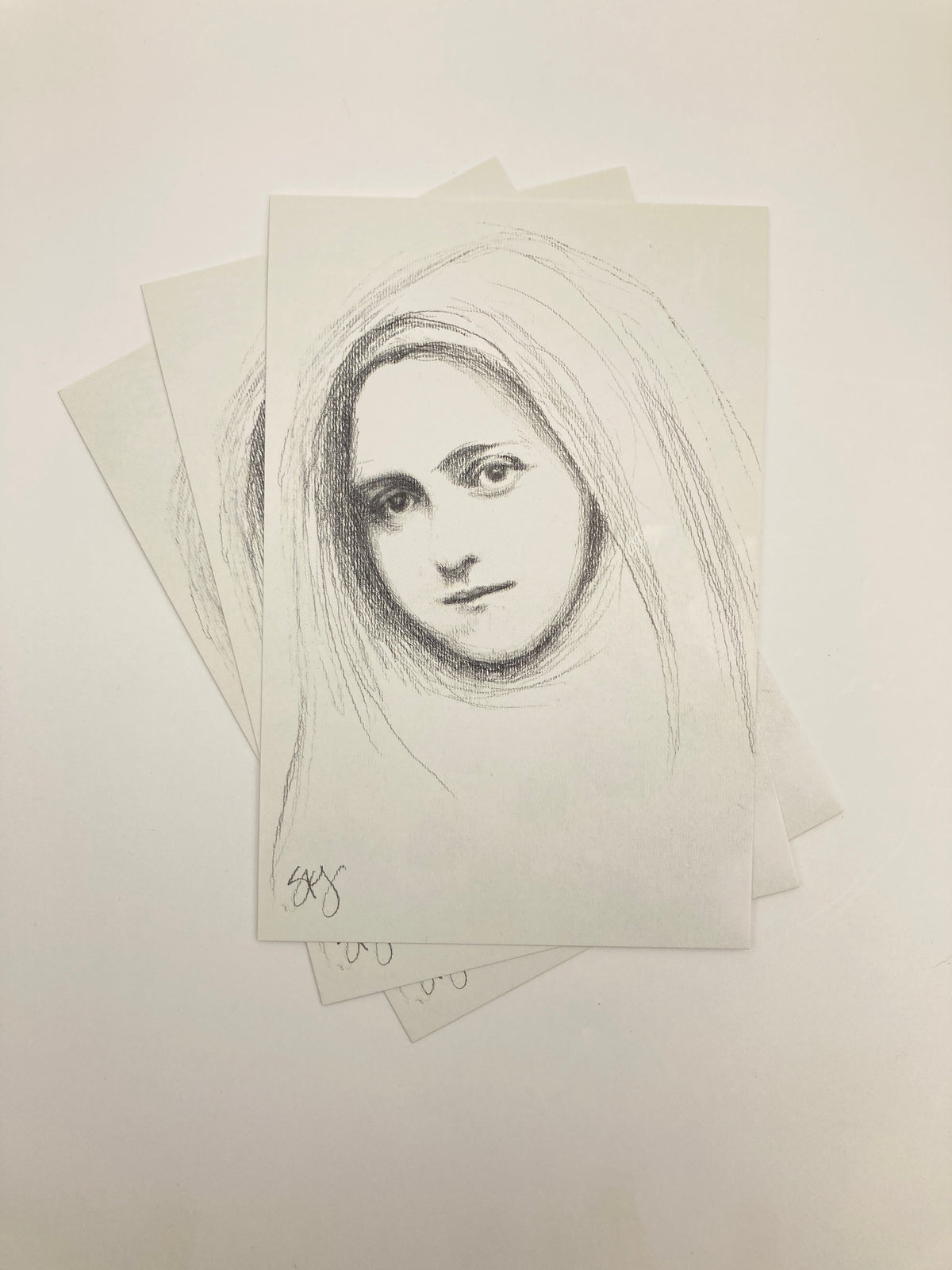 A sketch of a woman's face with flowing hair, depicted in a black and white style.