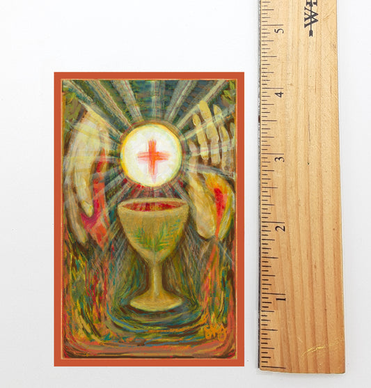 The image is a vibrant, colorful painting depicting a golden chalice with a red cross, surrounded by rays of light emanating from the center. The painting is framed within an orange border, and a ruler is placed next to it to provide a sense of scale.