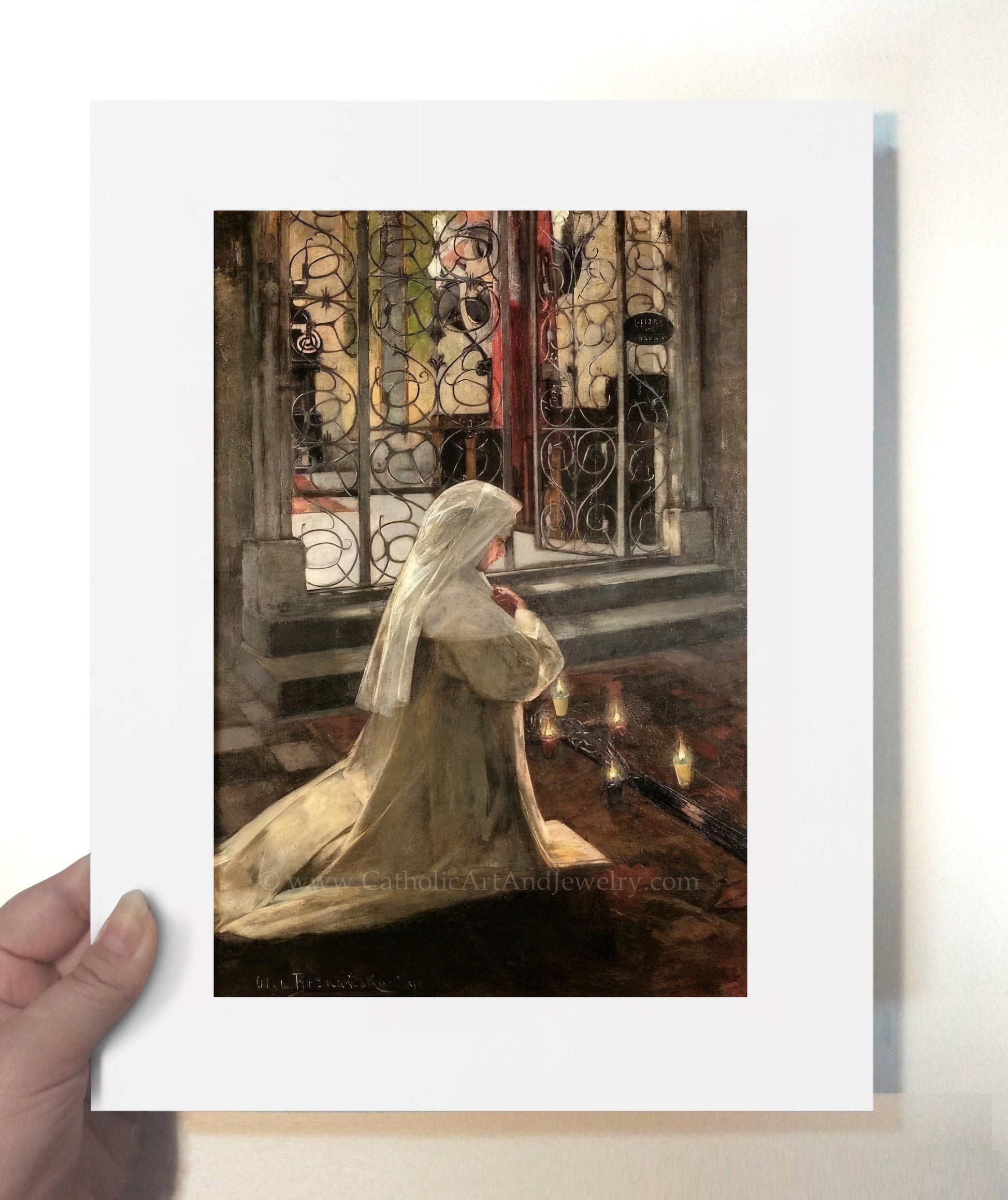 a person holding up a picture of a woman in a white dress