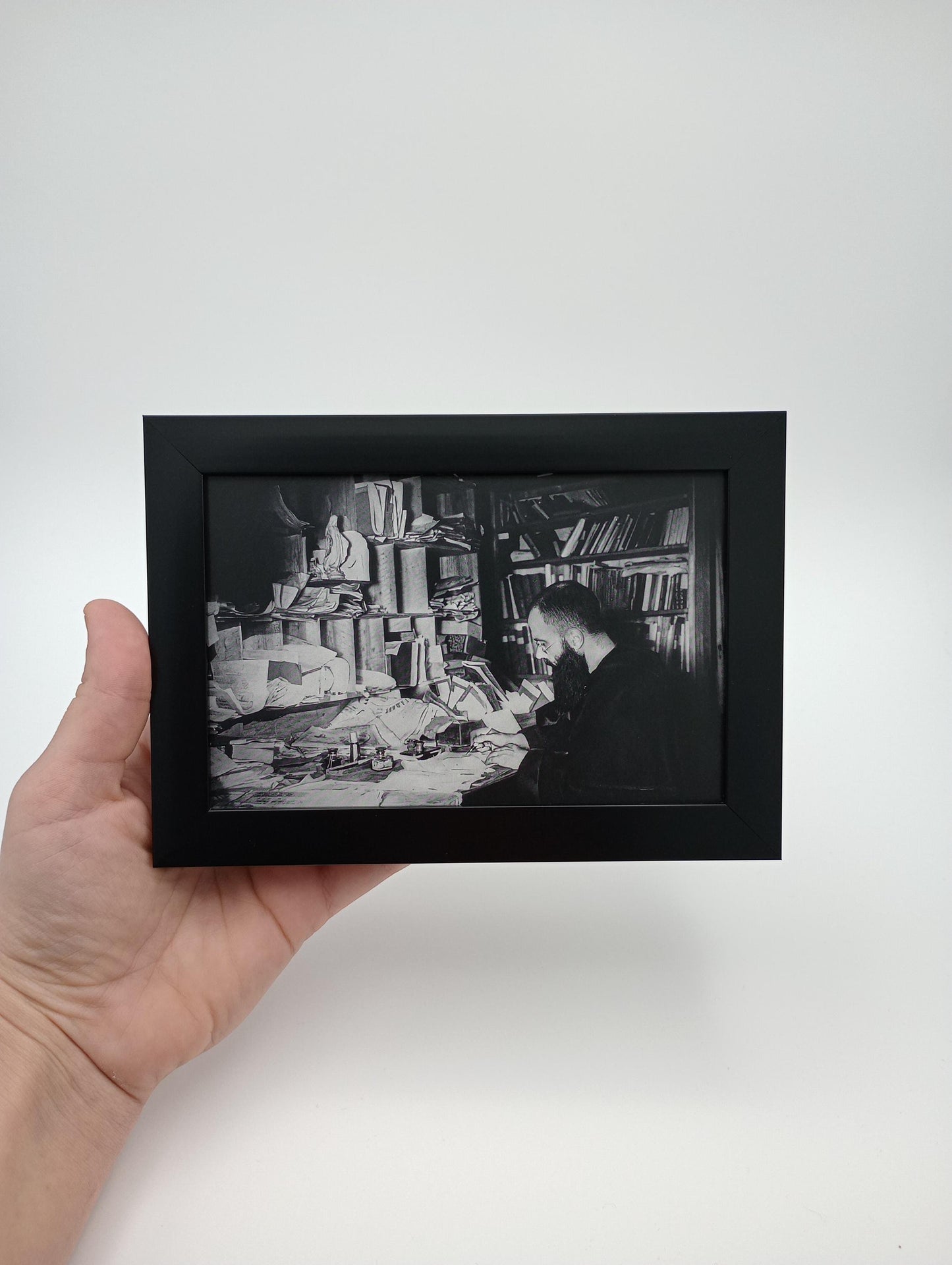 a hand holding a black and white photo