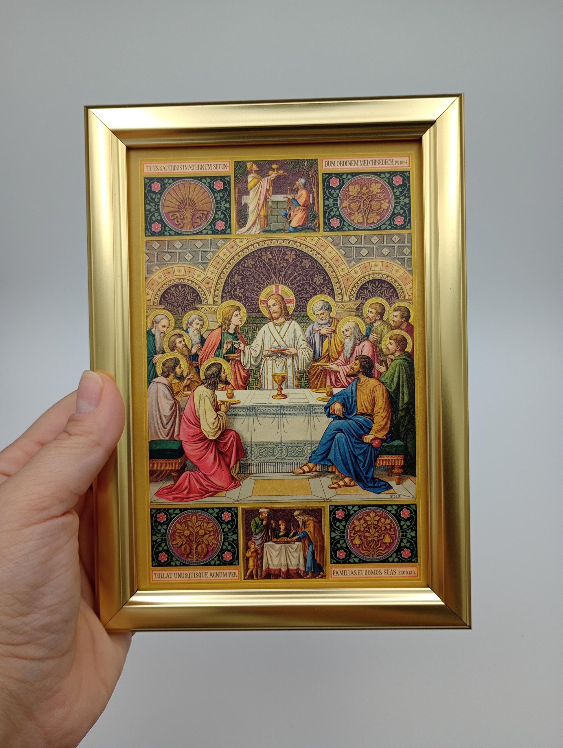 a person holding up a picture of a painting