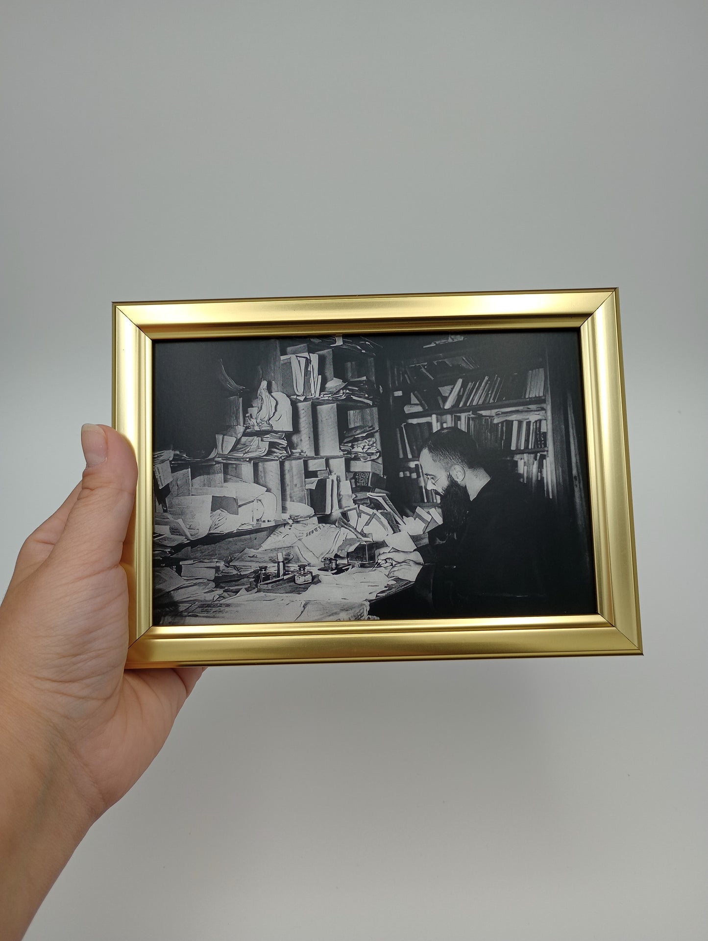 a person holding up a black and white photo