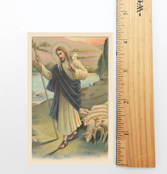 A religious illustration depicting a shepherd carrying a lamb, with mountains and a river in the background.