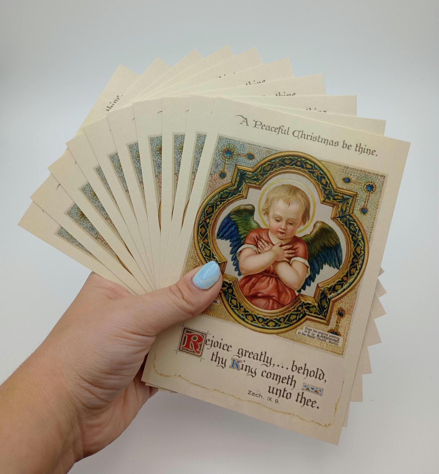 vintage Christmas postcards with a beautiful angel. The text says a peaceful Christmas be thine, and below the angel it says rejoice greatly for the king has come.