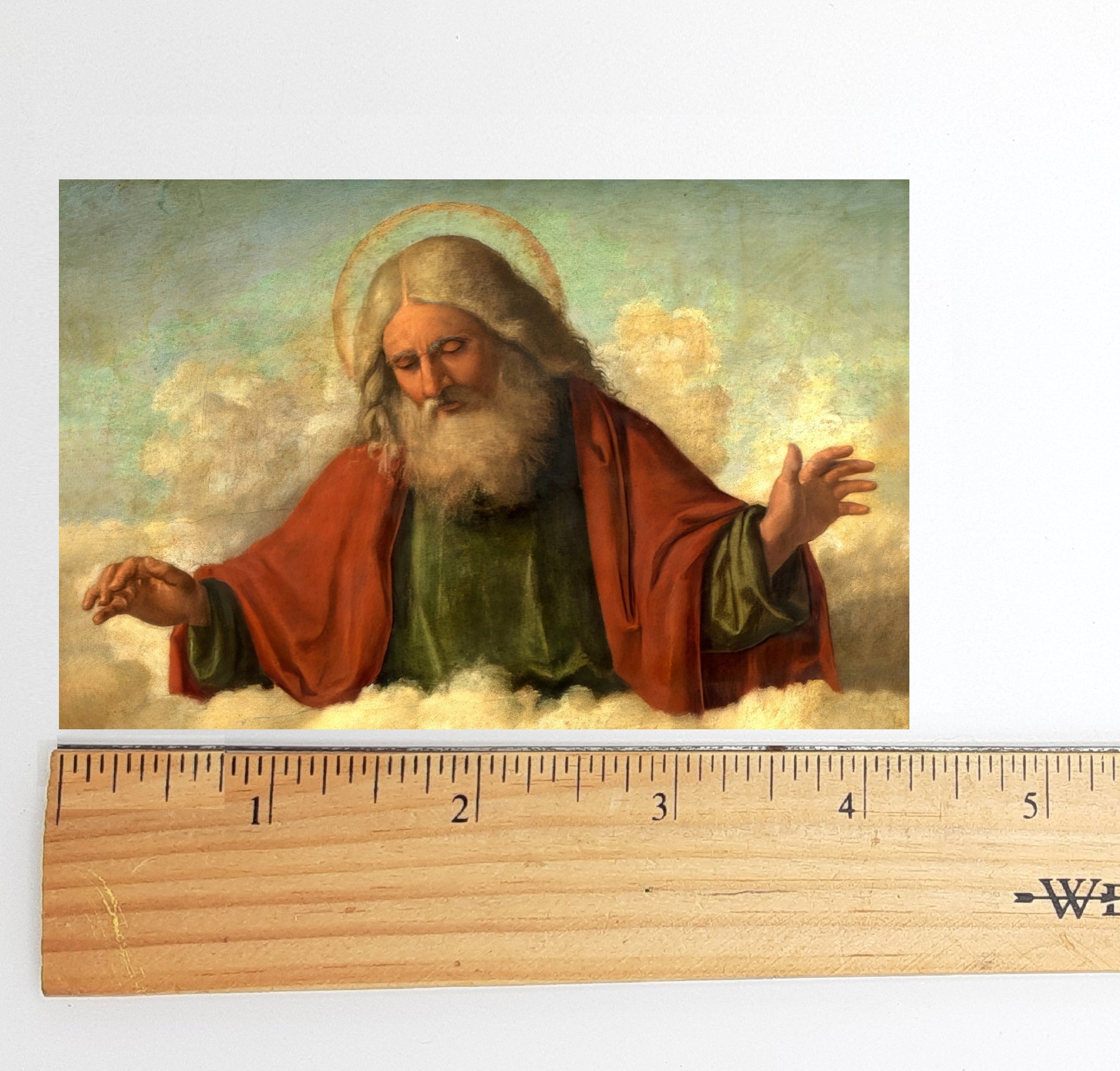 The image is a painting of a bearded man wearing a red robe, with clouds in the background.