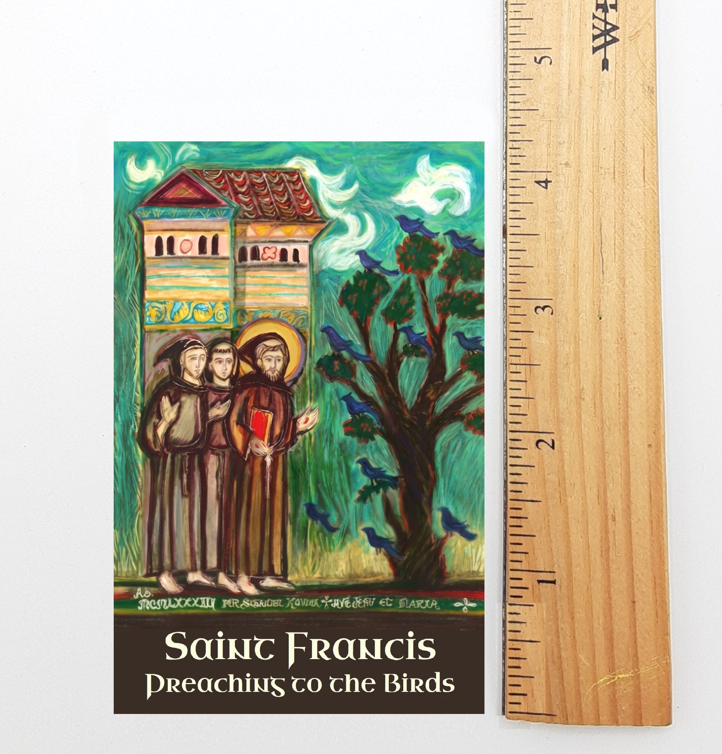 A colorful illustration of St. Francis of Assisi, with a group of people and birds in the background, along with the text "St. Francis Preaching to the Birds".