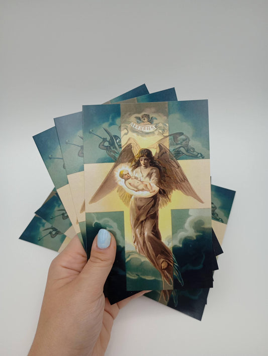a hand holding a bunch of cards with a picture of an angel on it