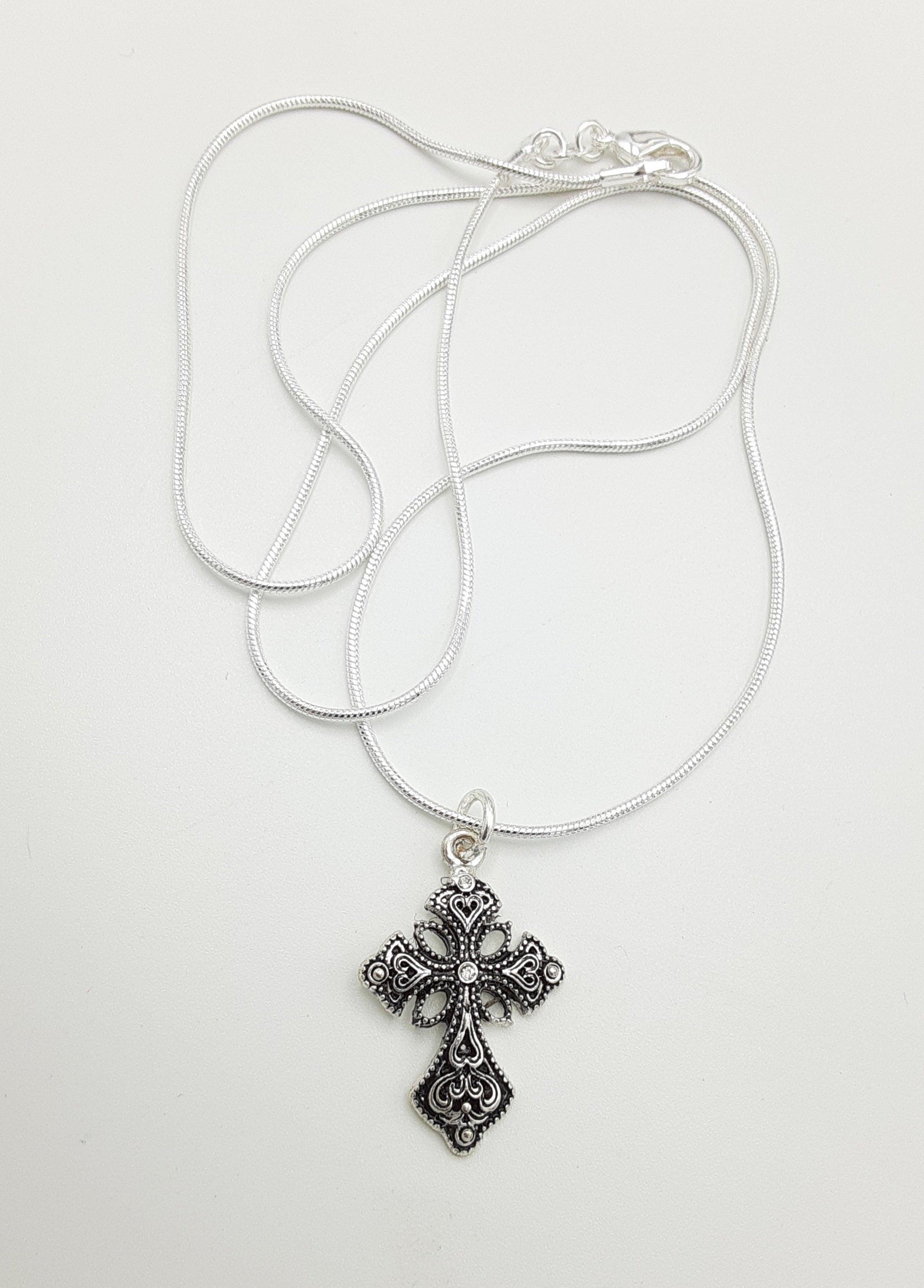 Free Photo | Ornate cross necklace shiny gold with gemstones generative AI